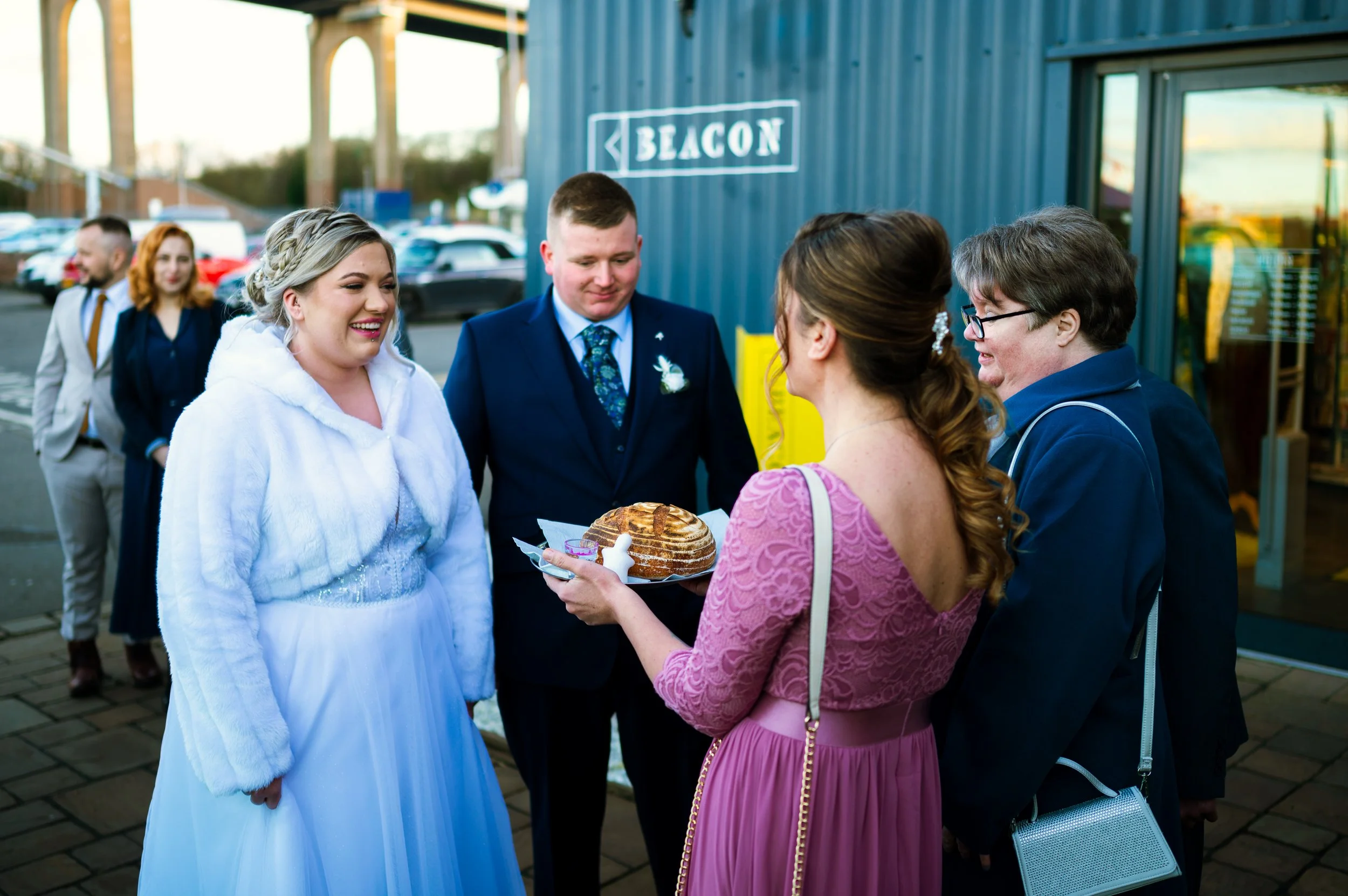 wedding reception restaurant dinner family members mom offering bread to couple polish tradition