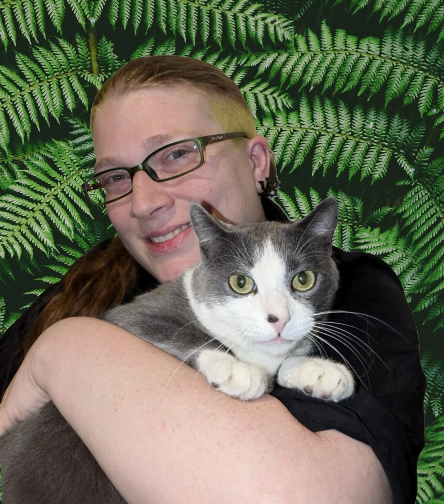 Dr Lorry Jolitz, a compassionate vet with red hair and green glasses holding a grey and white cat
