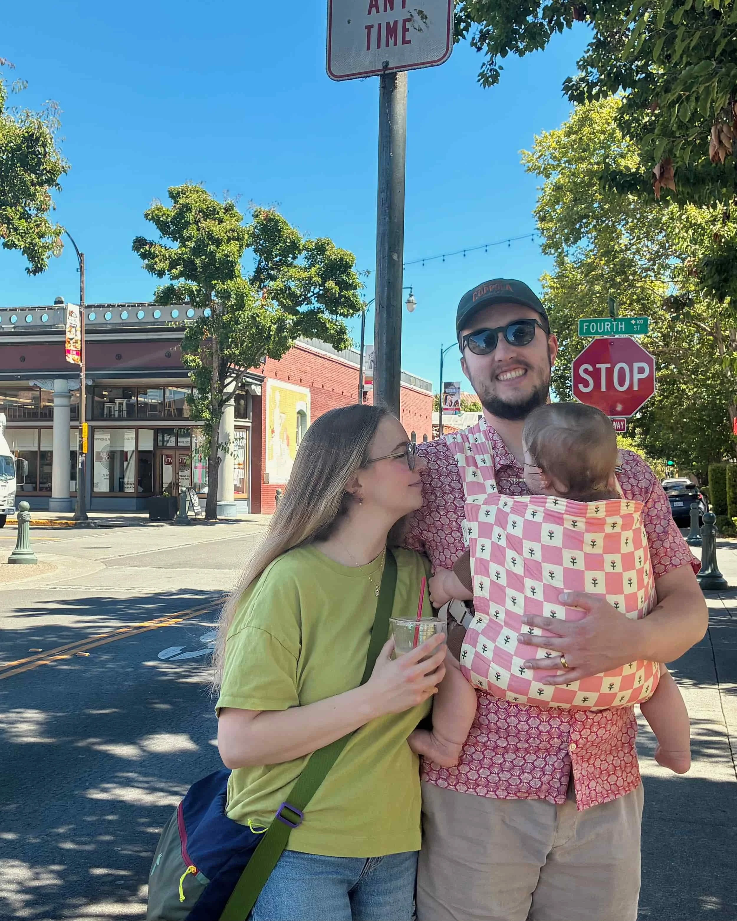 McCall with partner and child standing on a street corner