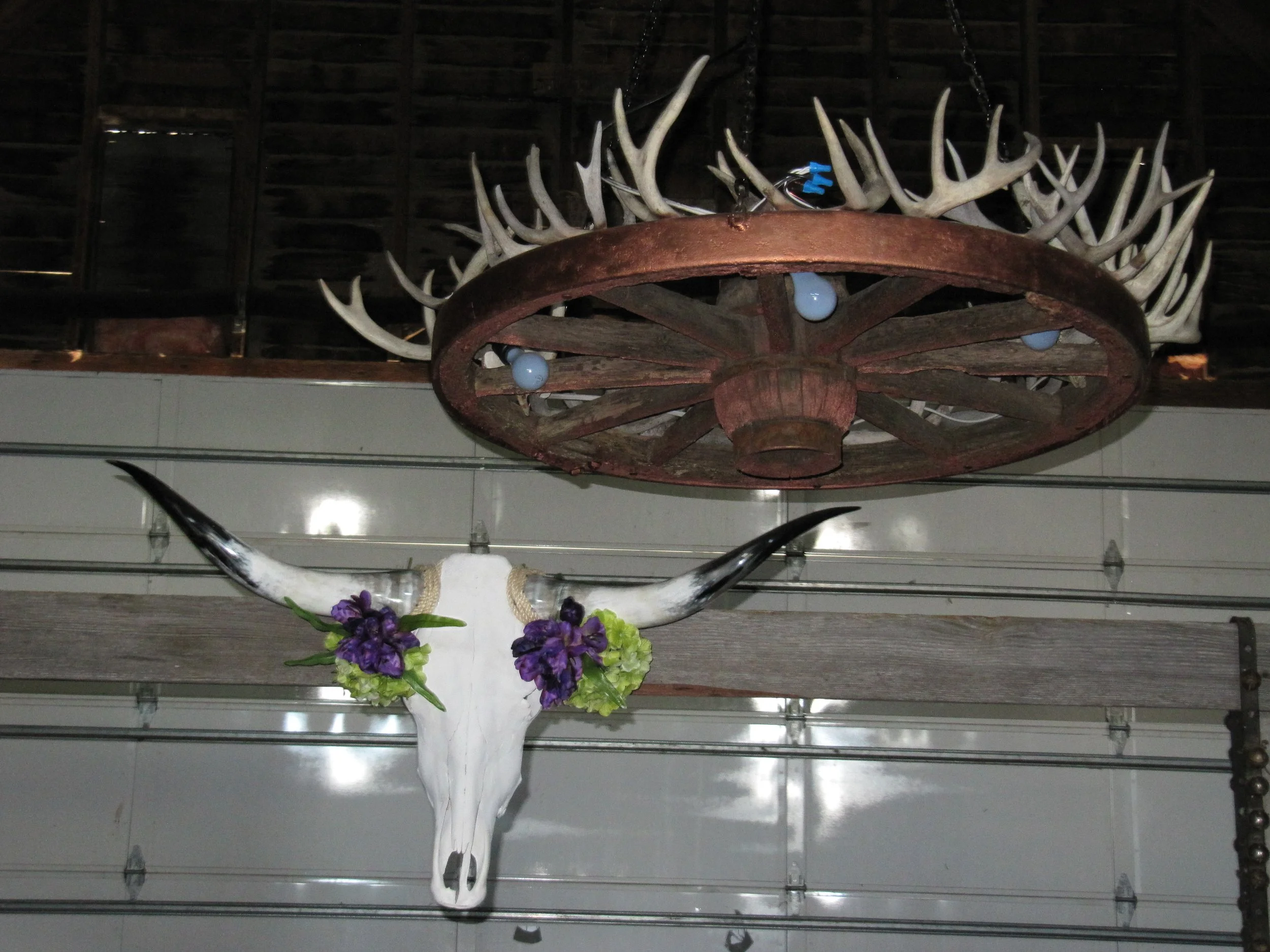 Antler chandelier and decorative western archway leading to the dance floor.