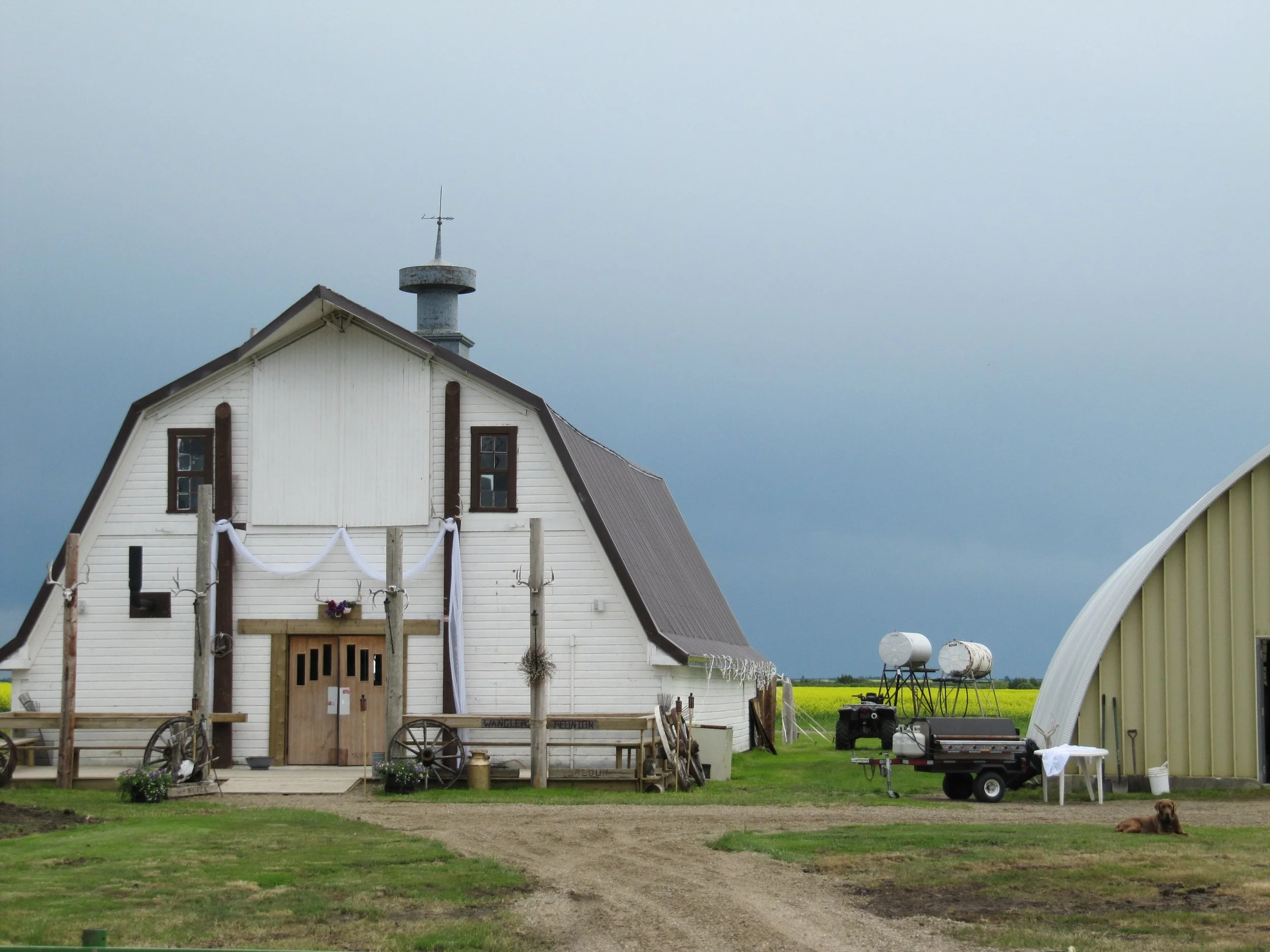 Rustic barn venue beneath a bright blue Saskatchewan sky