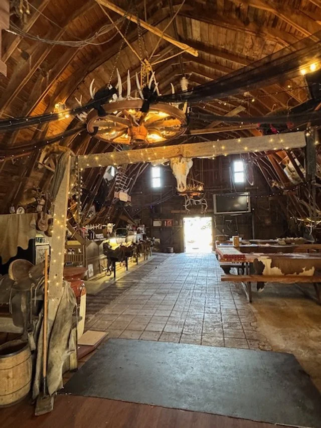 Interior of Top Gun Saloon with rustic antlers and entrance to dance floor.