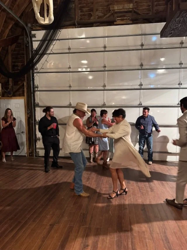 Wedding guests enjoying the dance floor with a couple dancing.
