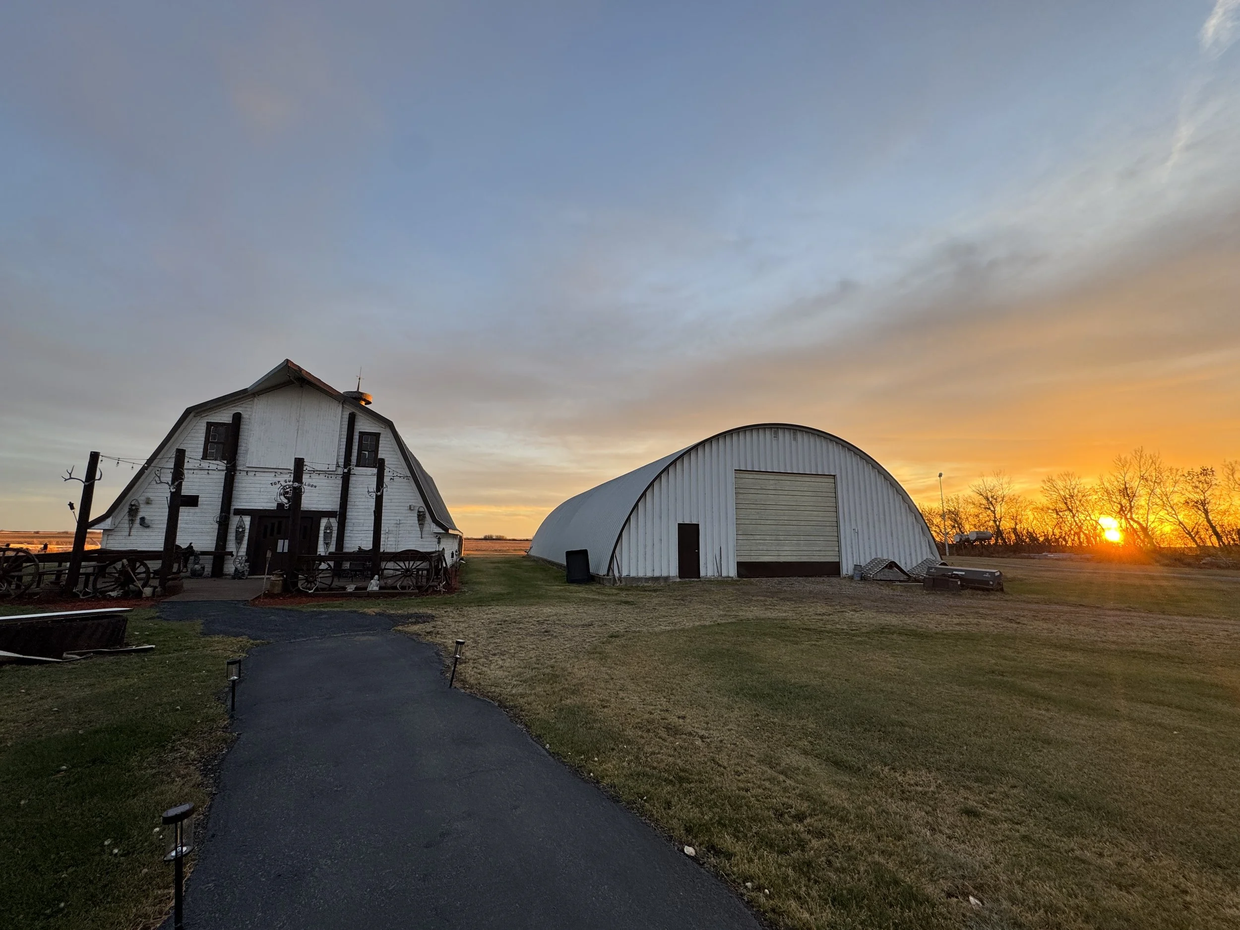 Sunset over the Top Gun Saloon and the nearby Quonset building.