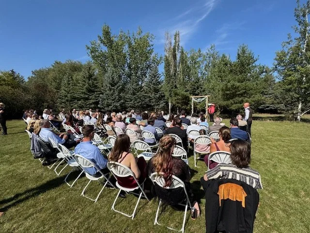 Close up of wedding guests seated during the outdoor ceremony.