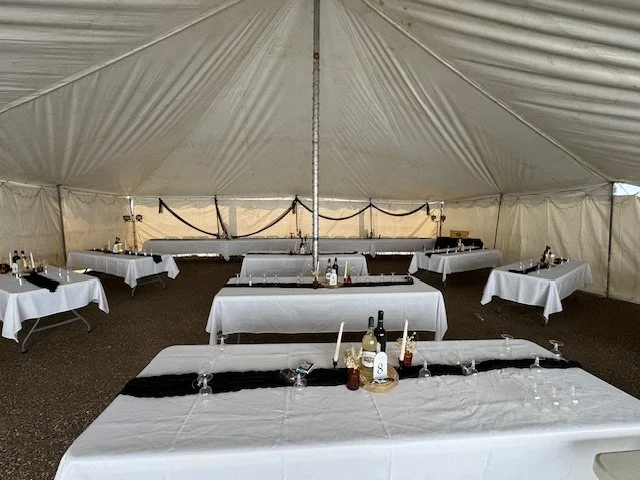 Spacious event tent prepared for wedding receptions and private celebrations.