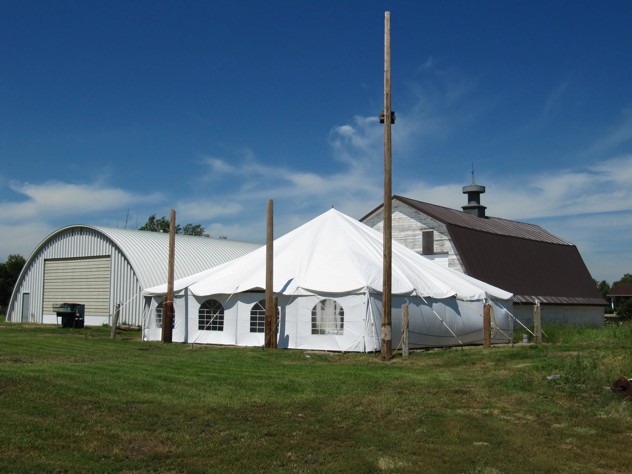 White event tent behind Top Gun Saloon prepared for a special celebration.