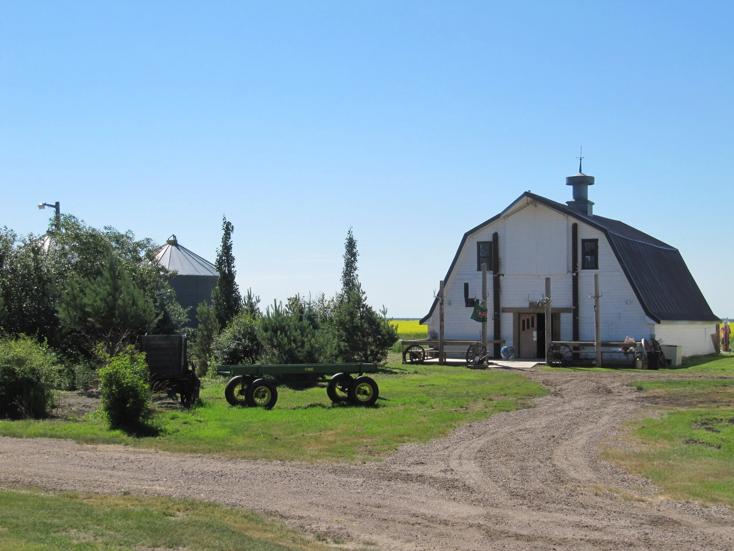 Front of Top Gun Saloon with landscaped grounds, driveway and welcoming entrance.