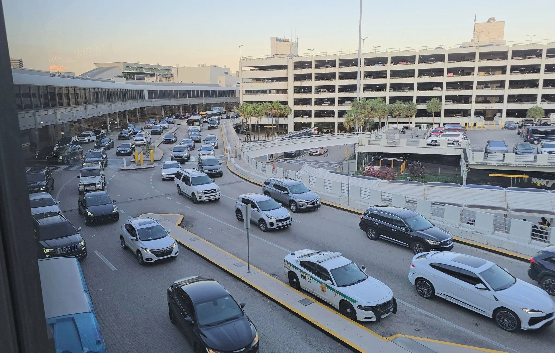 Miami International Airport arrivals and pickup area with traffic before transferring to  PortMiami cruise port