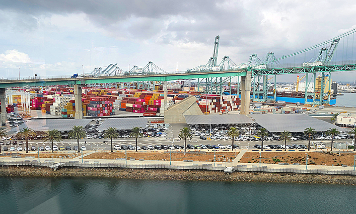 Port of Los Angeles cruise terminal in San Pedro, California, with container port cranes, parking area, and waterfront views