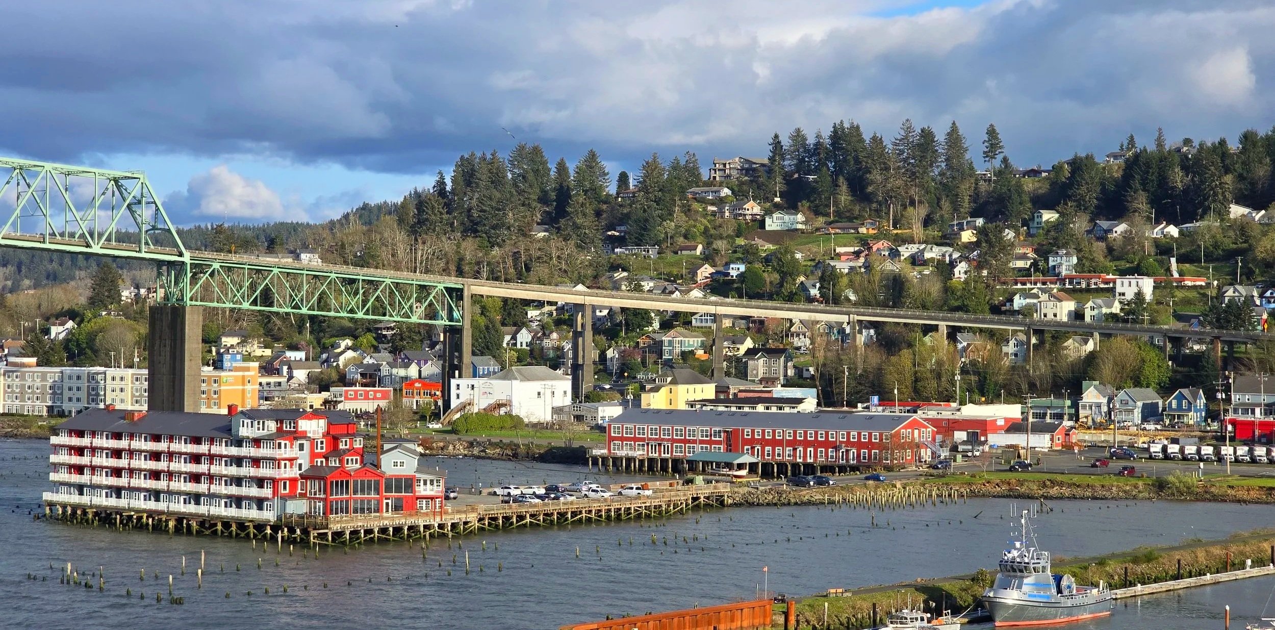 Astoria, Oregon waterfront near the cruise port with the Astoria-Megler Bridge, Columbia River, hillside homes, and historic waterfront buildings