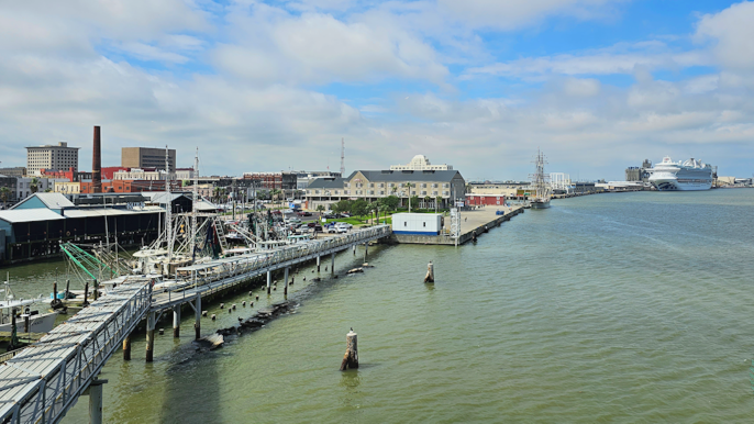Galveston, Texas waterfront near the cruise port with harbor views, historic buildings, and a cruise ship docked in the distance