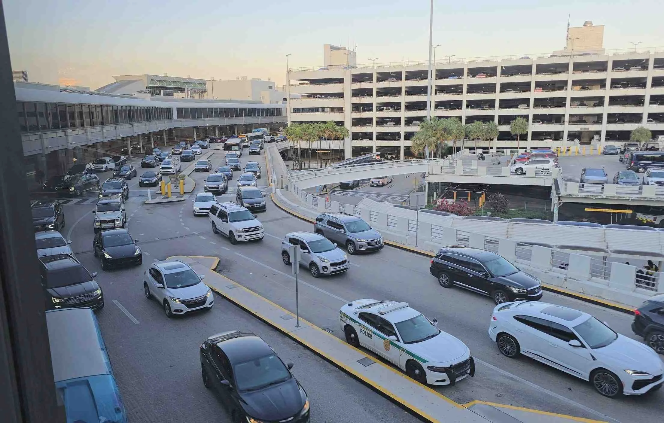Miami International Airport arrivals and pickup area with traffic before transferring to  PortMiami cruise port