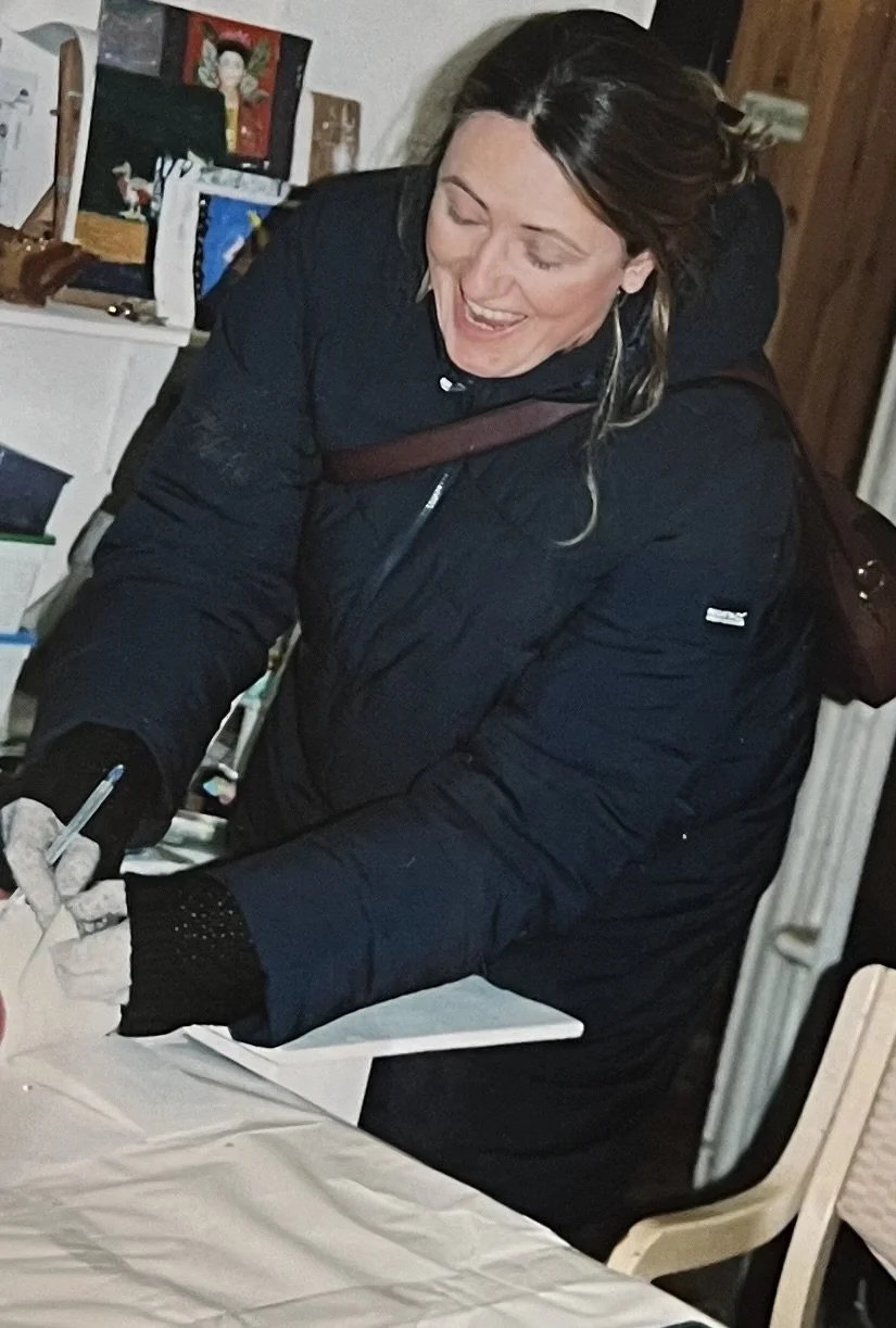 Woman in blue coat looking cheerful