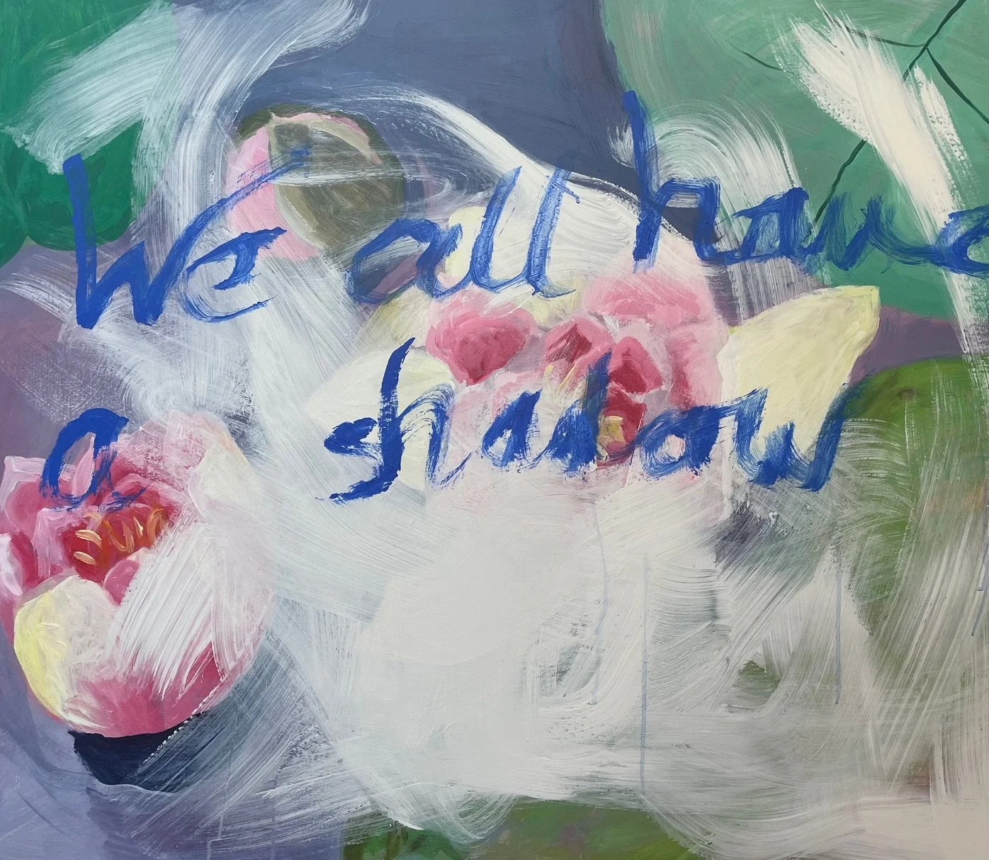 A large water lily brushed over with white paint cheerful colours and blue writing: 'We all have a shadow'