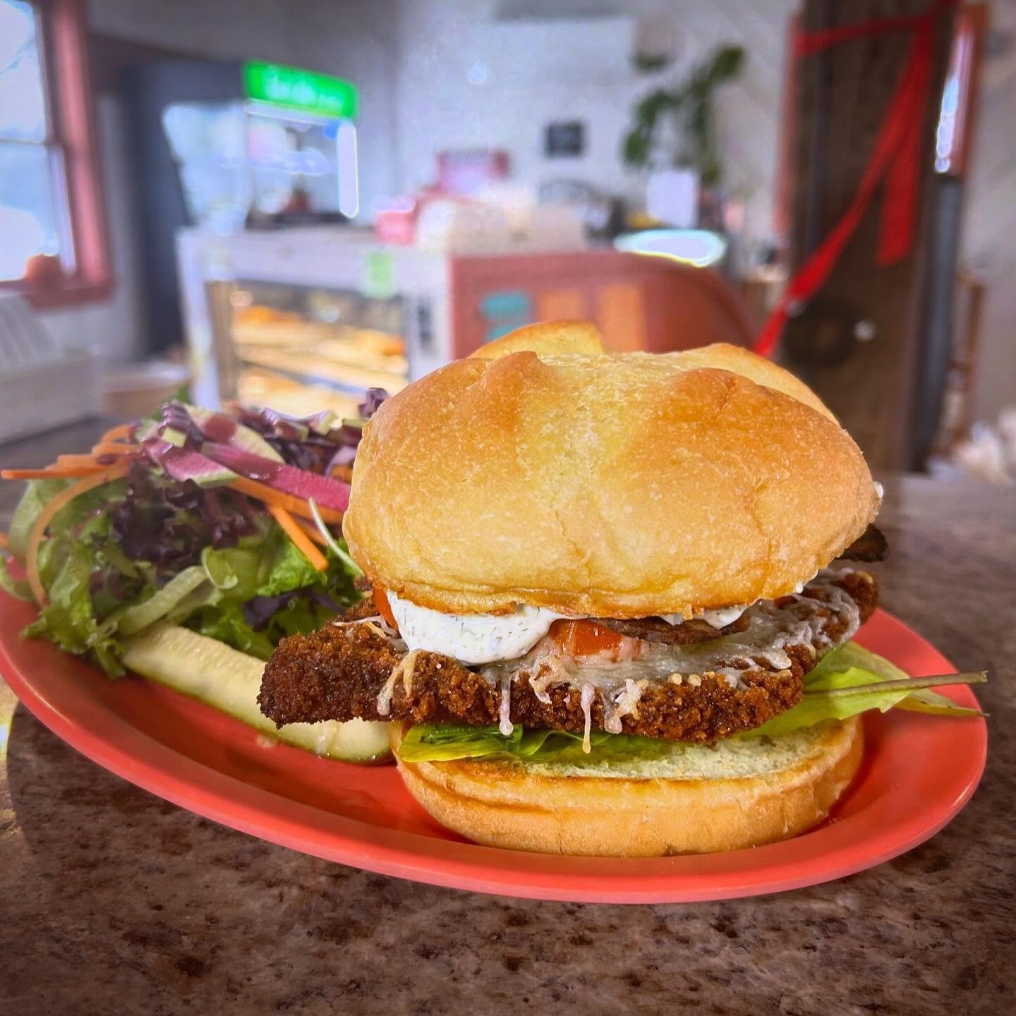 An hourglass filled with blue sand next to a calendar showing dates in the month.