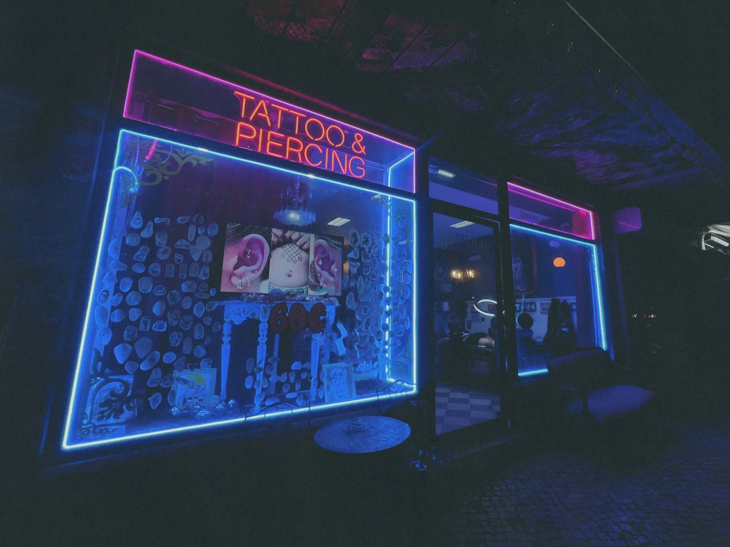 Cacilhas Tattoo Studio interior, Lisbon - pink and blue neon Tattoo & Piercing sign