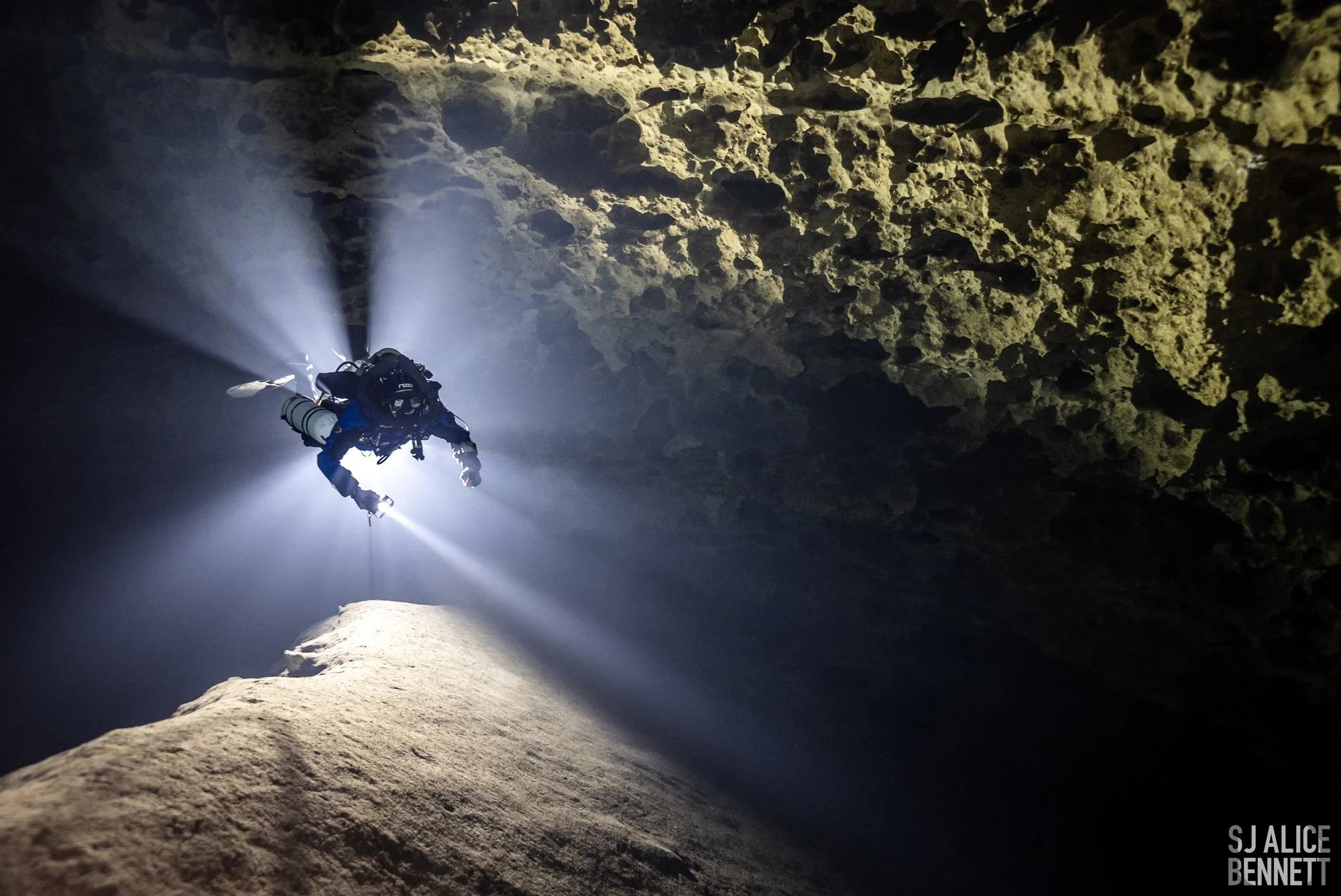 Cave diver swimming inside Mill Creek Sink, courtesy of SJ Alice Bennett.