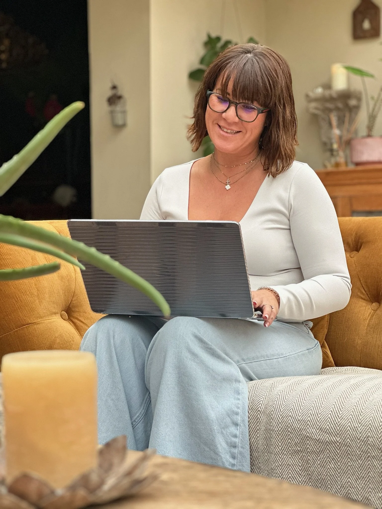 Jodie Horgan working on a laptop in a relaxed setting, leadership coach and business founder