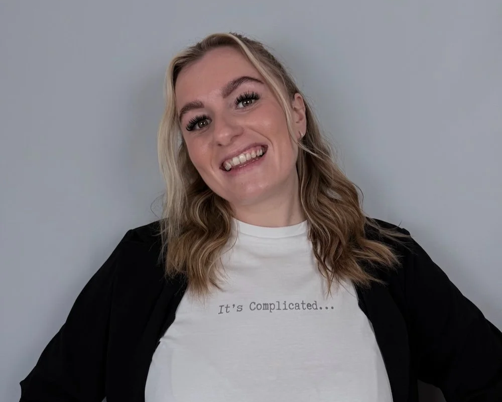 Rach wearing a white its complicated t-shirt and black cardigan