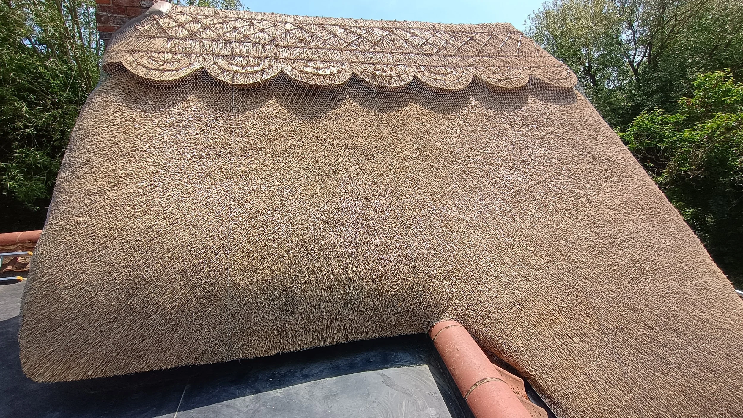 Re-thatched roof with pattern ridge