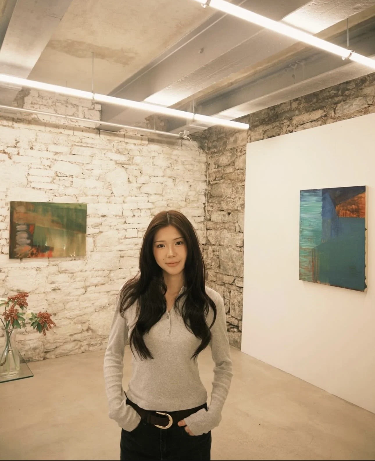 a woman infront of an artwork