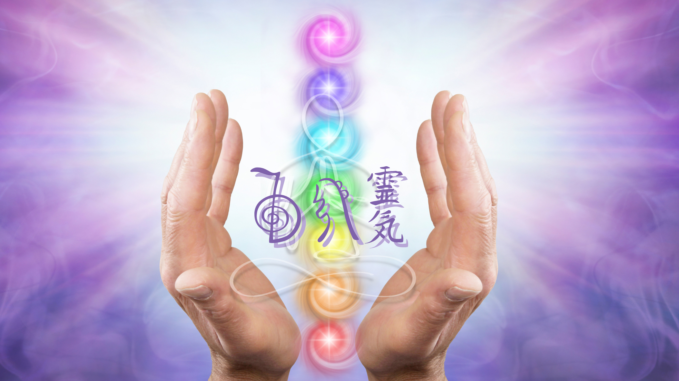 Hands with palms facing inward surround a vertical array of colorful glowing orbs and Japanese characters representing energy centers on a purple and blue mystical background.