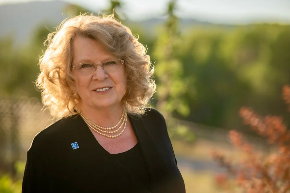 Headshot photo of Cindy Stevick with glowing sunset light