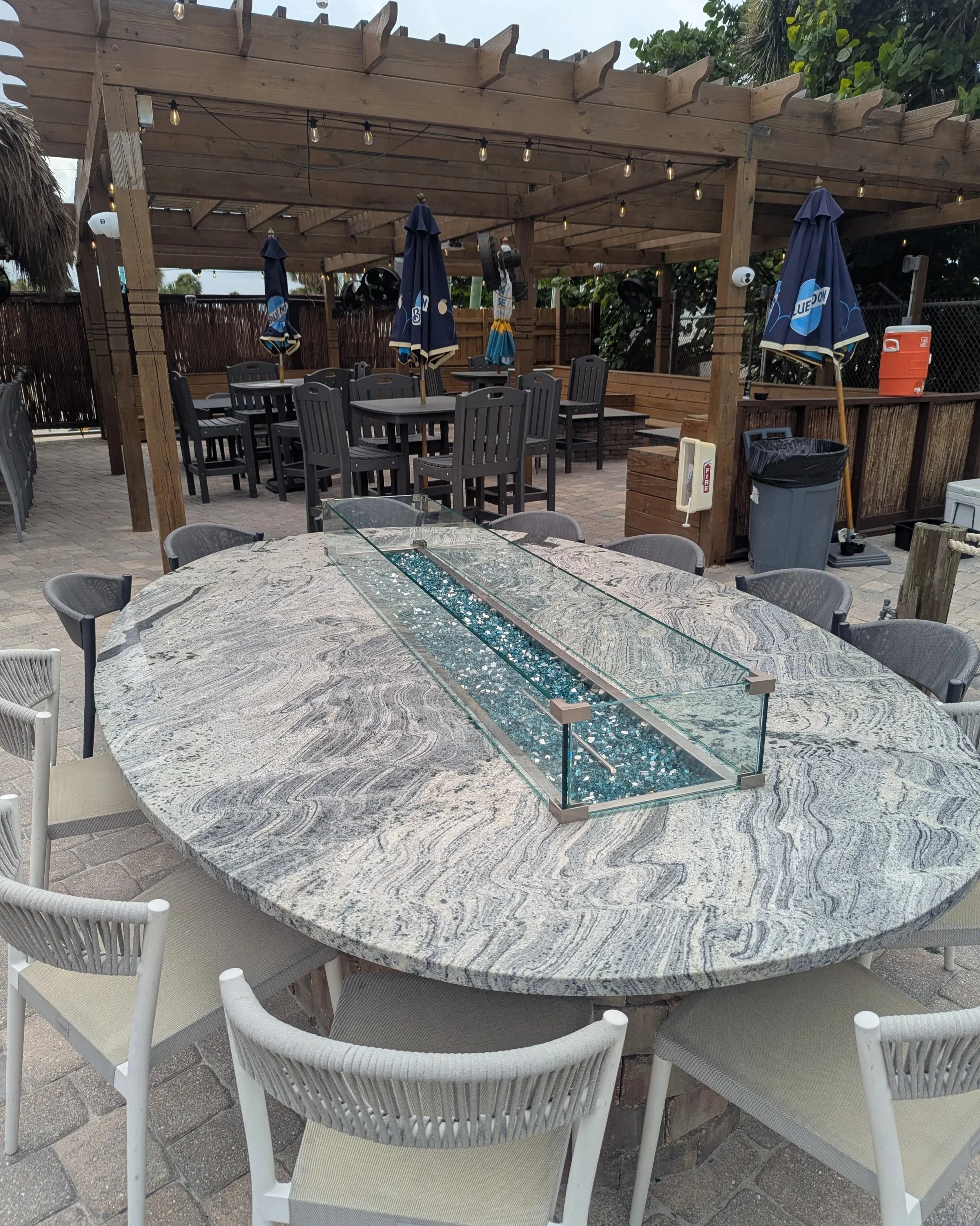 Outdoor patio with custom glass enclosure for patio fire table