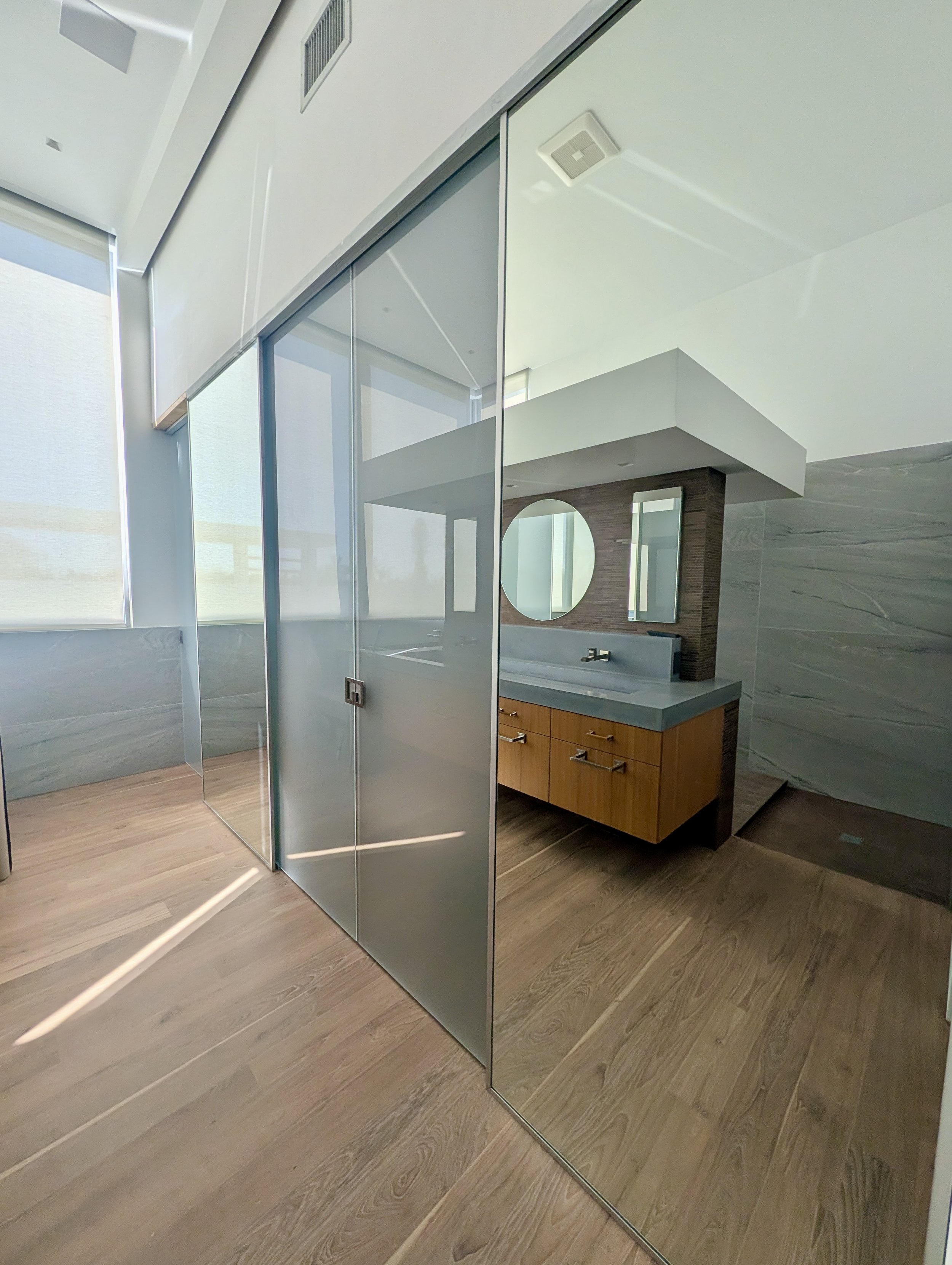 custom frosted glass and mirrors as a triple pocket door systme