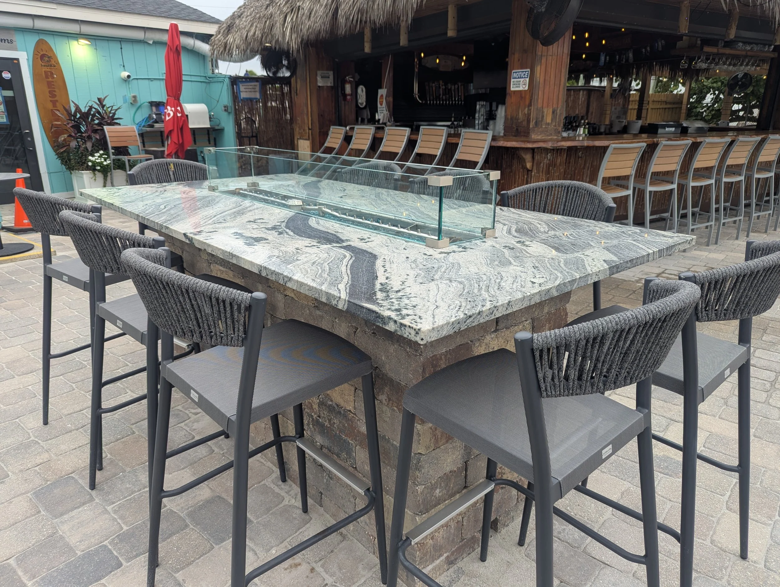 Outdoor patio with custom glass enclosure for patio fire table
