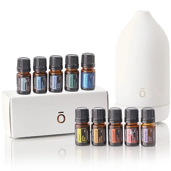 Set of essential oils with a white diffuser and eight small bottles of different scents.