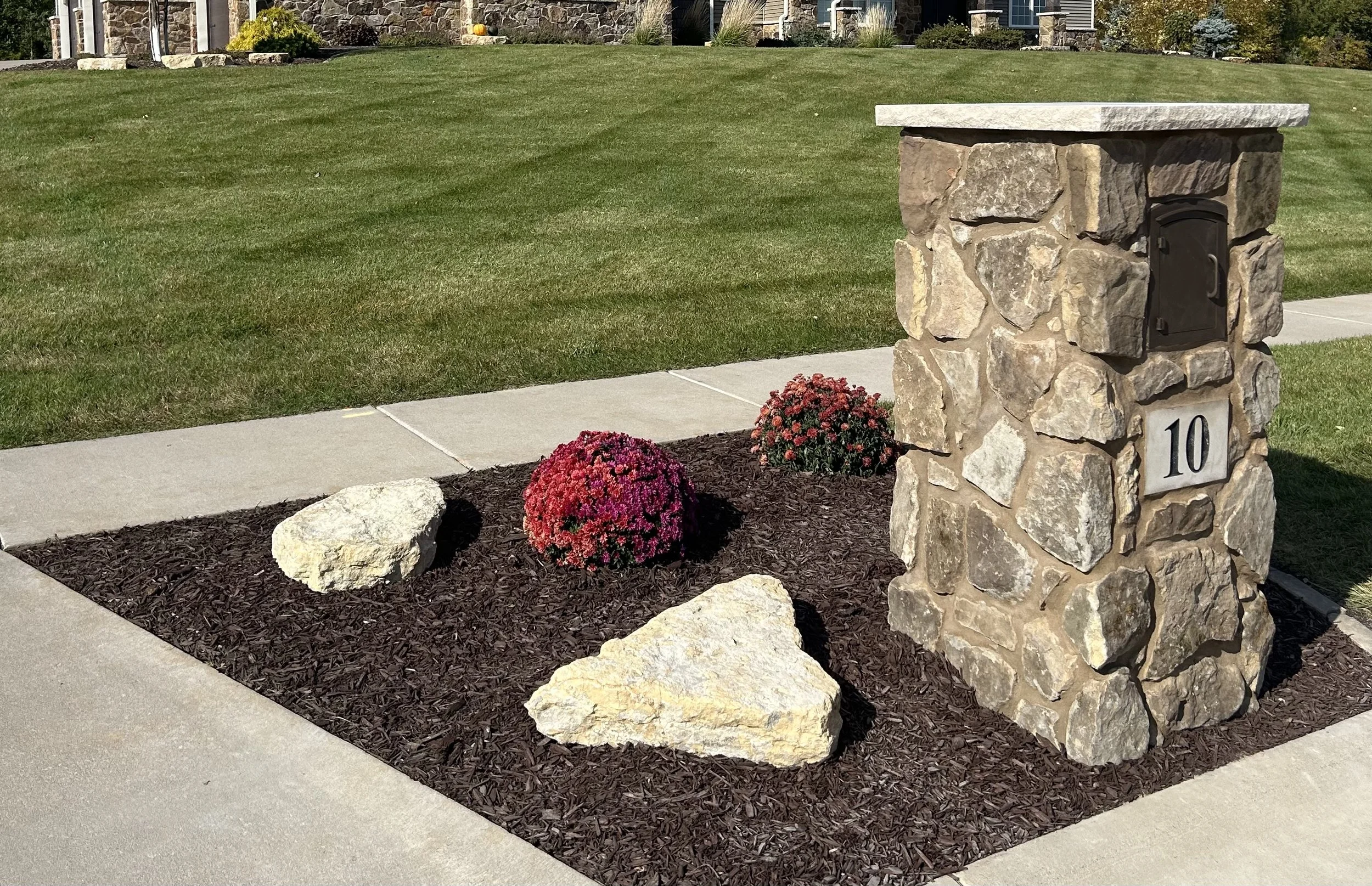Custom residential mailbox installation with modern landscaping