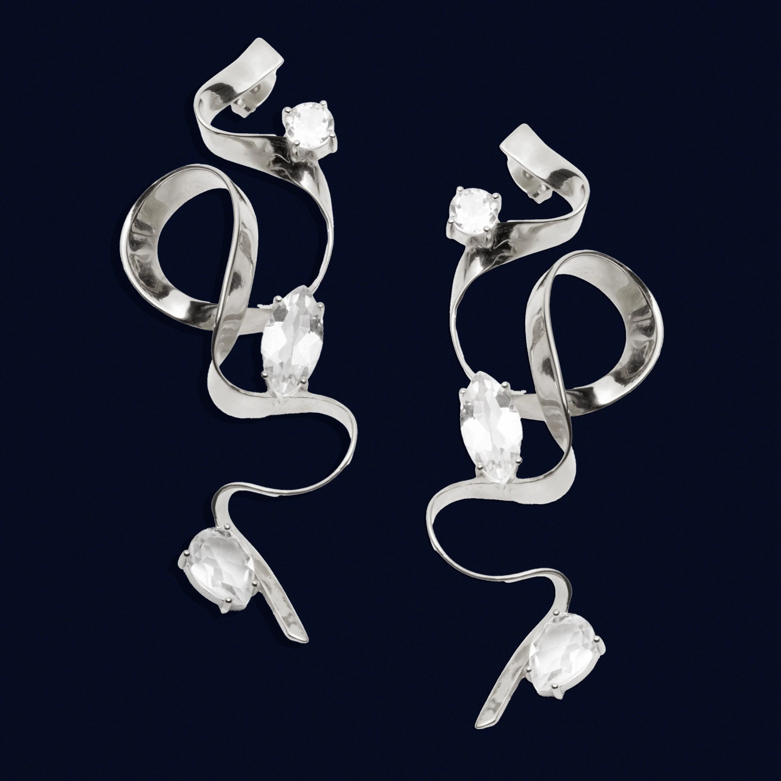 sterling-king-crystal-ribbon-statement-earrings-sterling-silver-navy-background.jpg