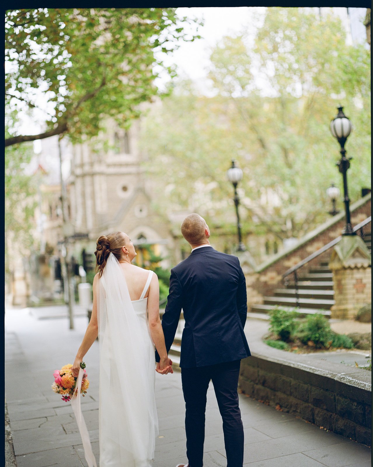 Bride and groom walking through Melbourne CBD after their intimate micro wedding ceremony.