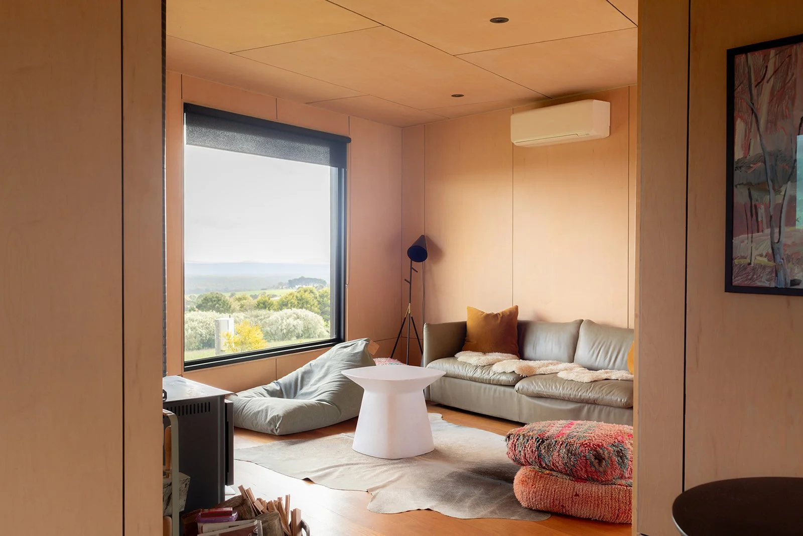 a light and airy accommodation, sun streams through the windows with rolling green hills outside of the window.