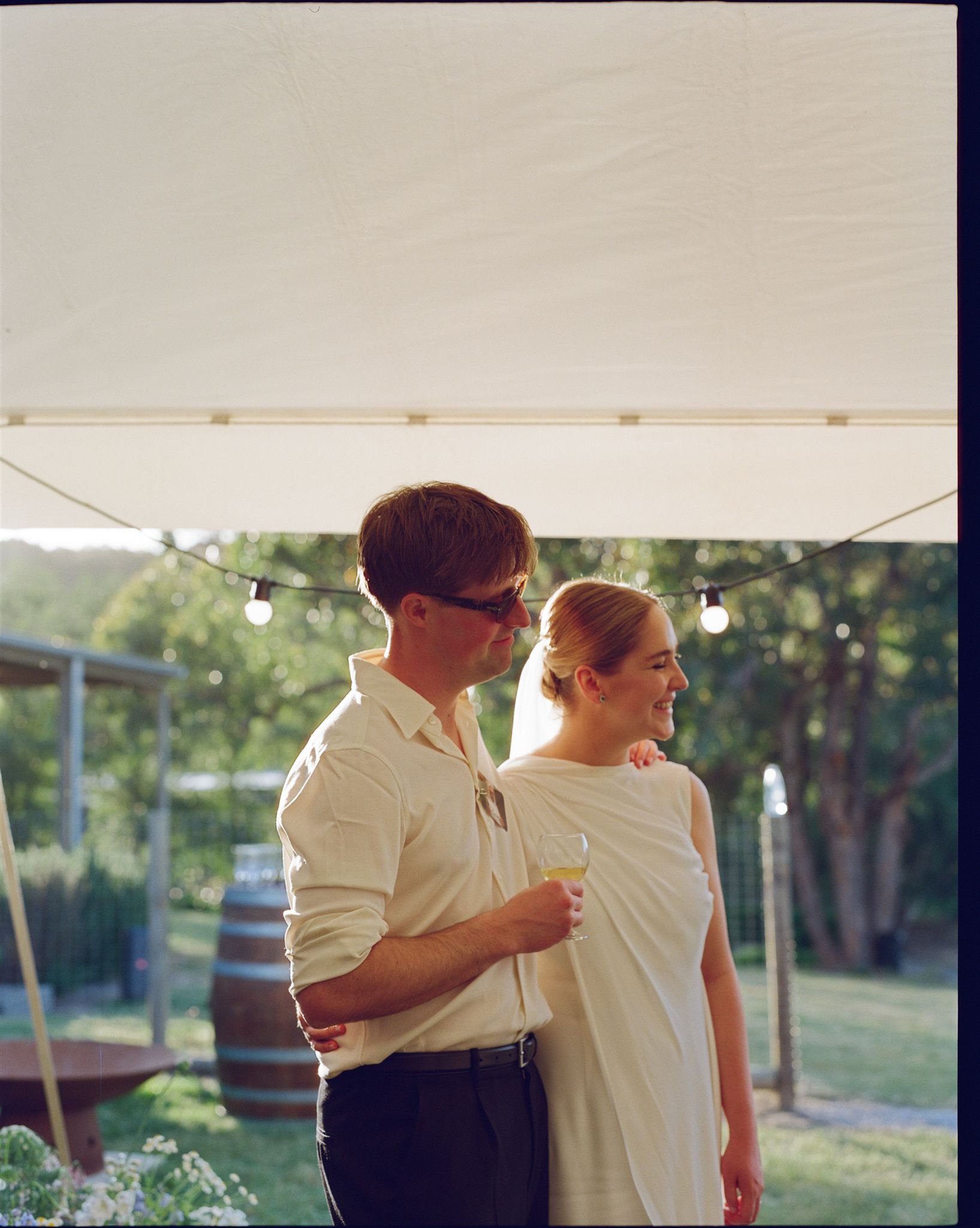 Candid moment between bride and groom at Melbourne wedding reception on film