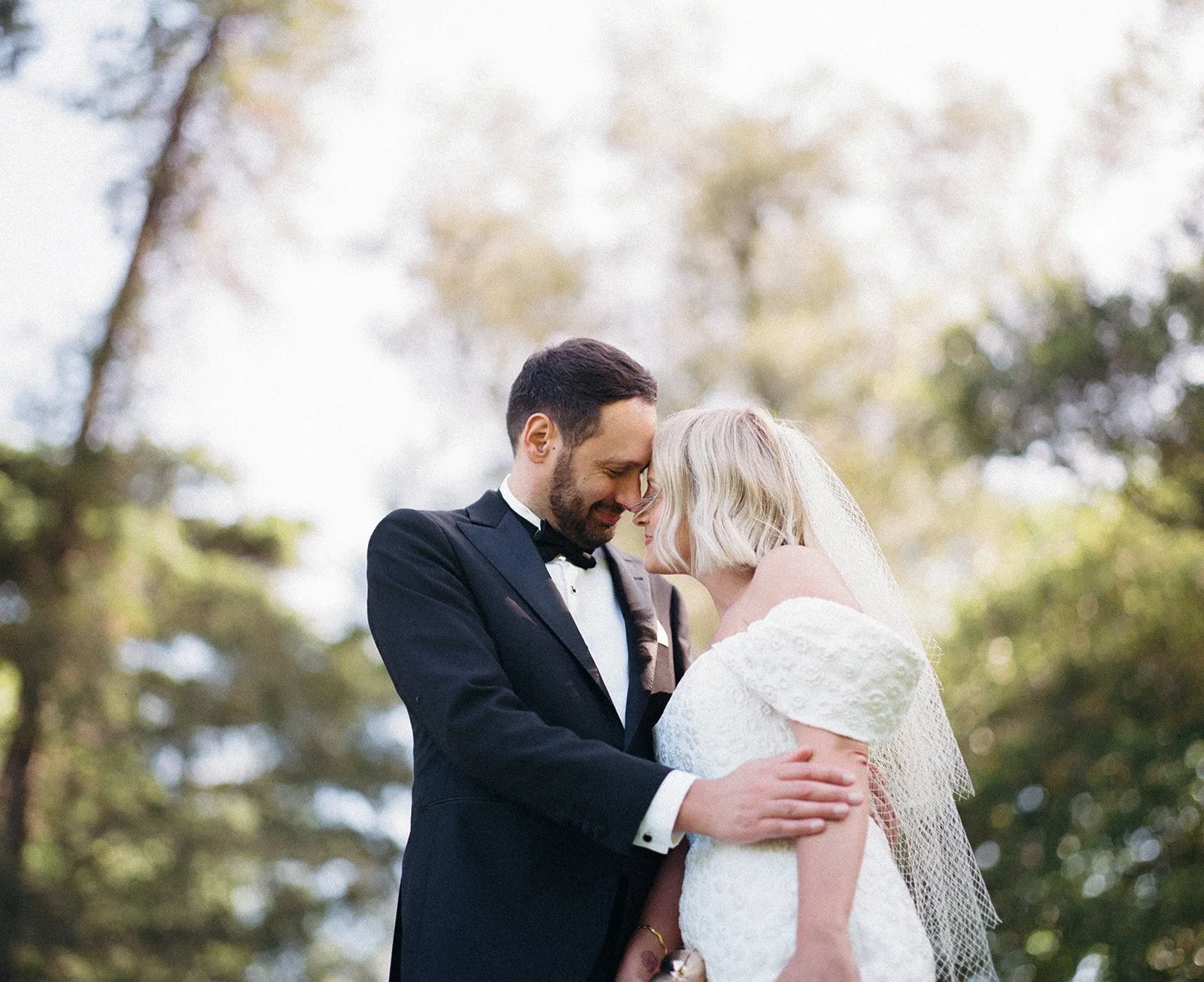 a film photograph of a bride and groom embracing in Melbourne botanical gardens during golden hour.