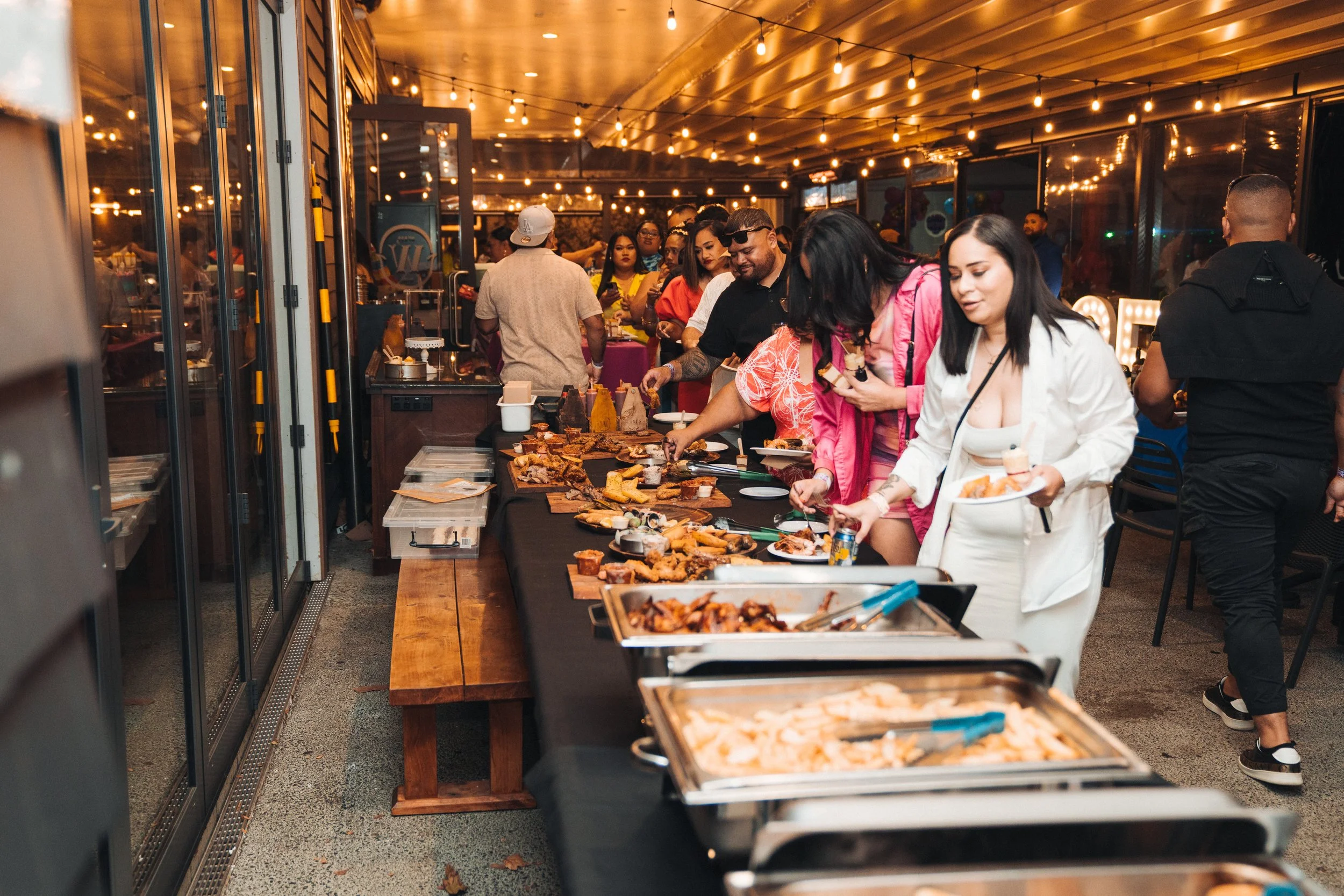 Group of people dining indoors with a "SuperGold Perks" sign offering 10% discount for Gold Card holders.
