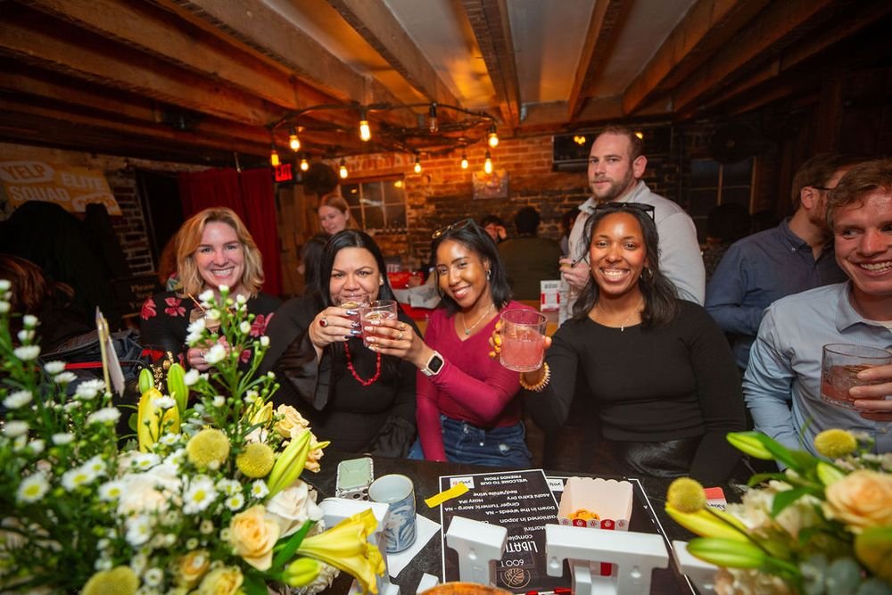 women cheers-ing at a bar 