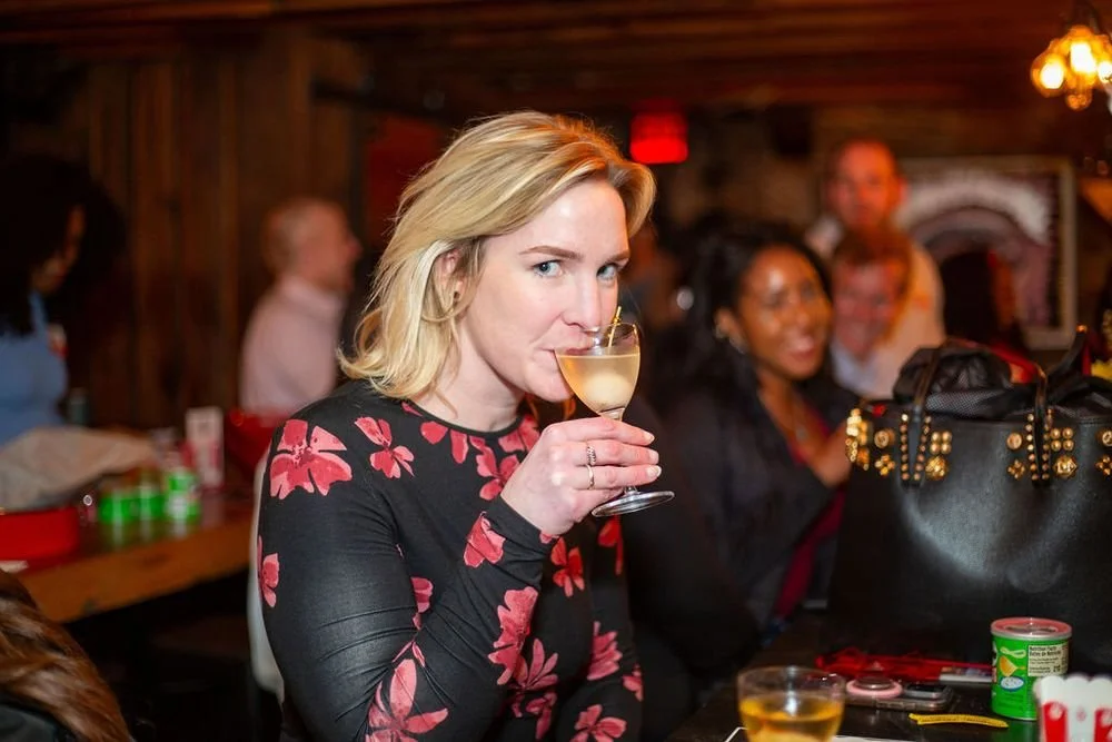woman sips on a drink