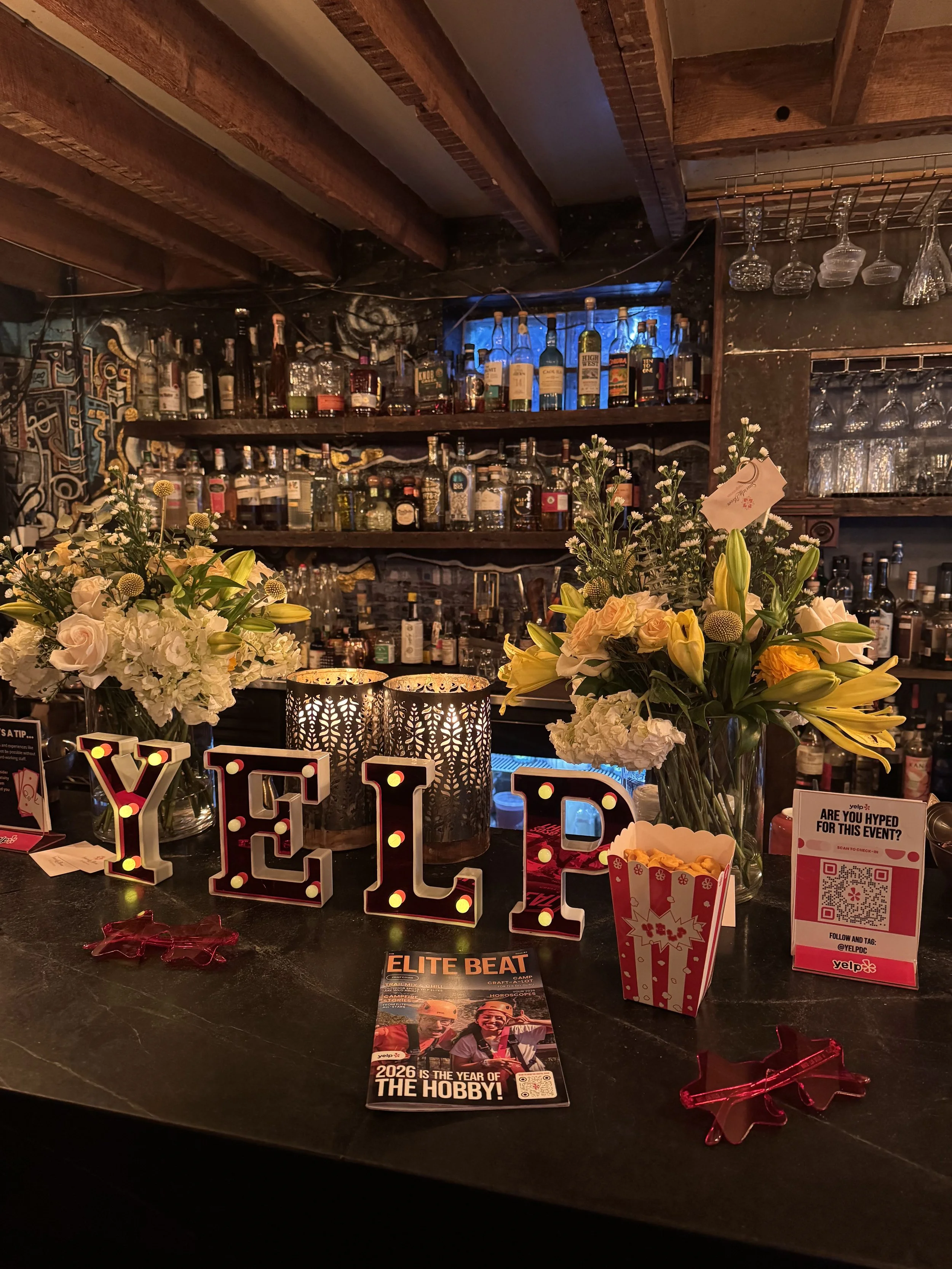 Yelp sign with flowers at a bar