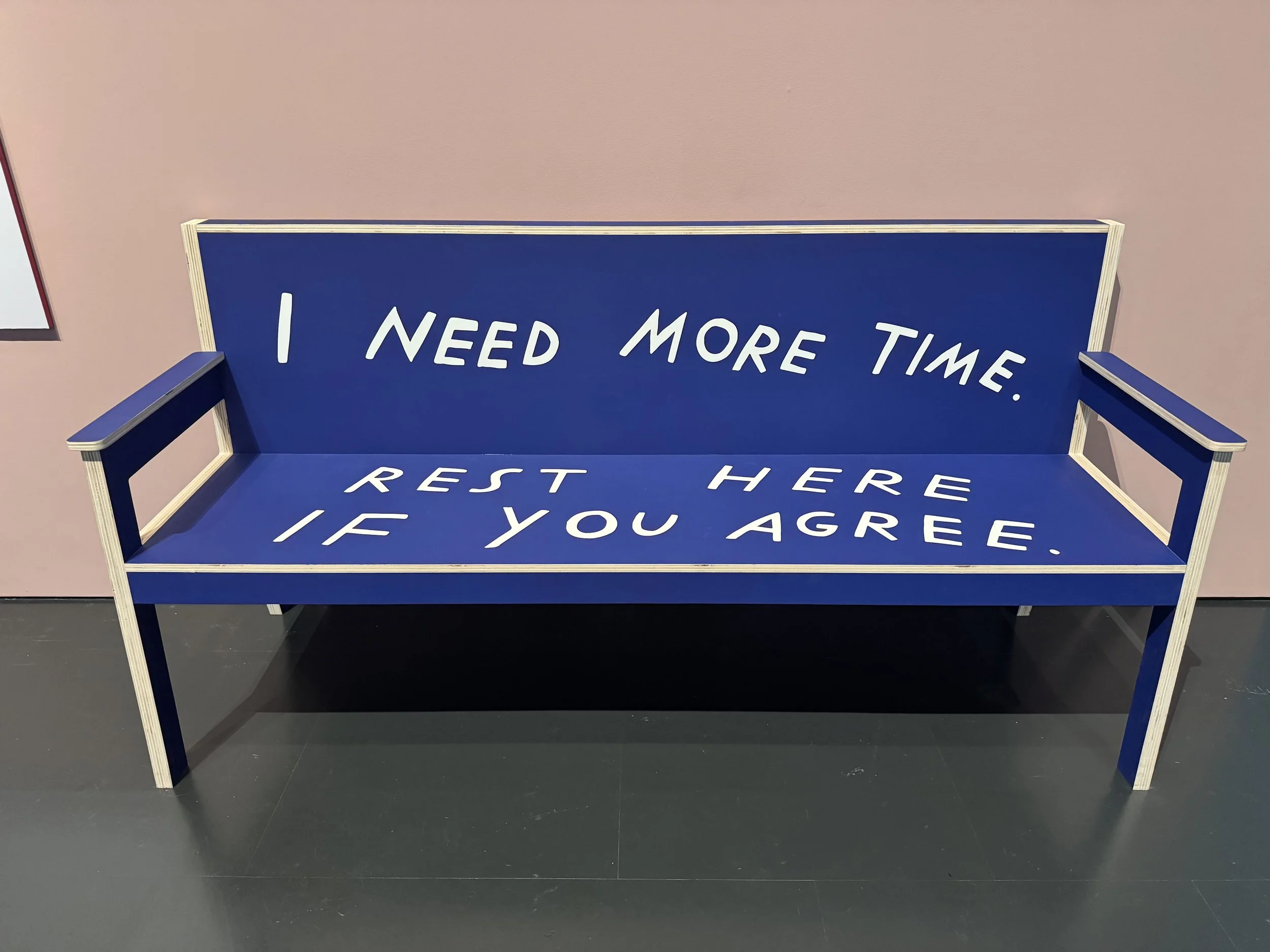 A bench seat with the words " I need more time. Rest here if you agree"