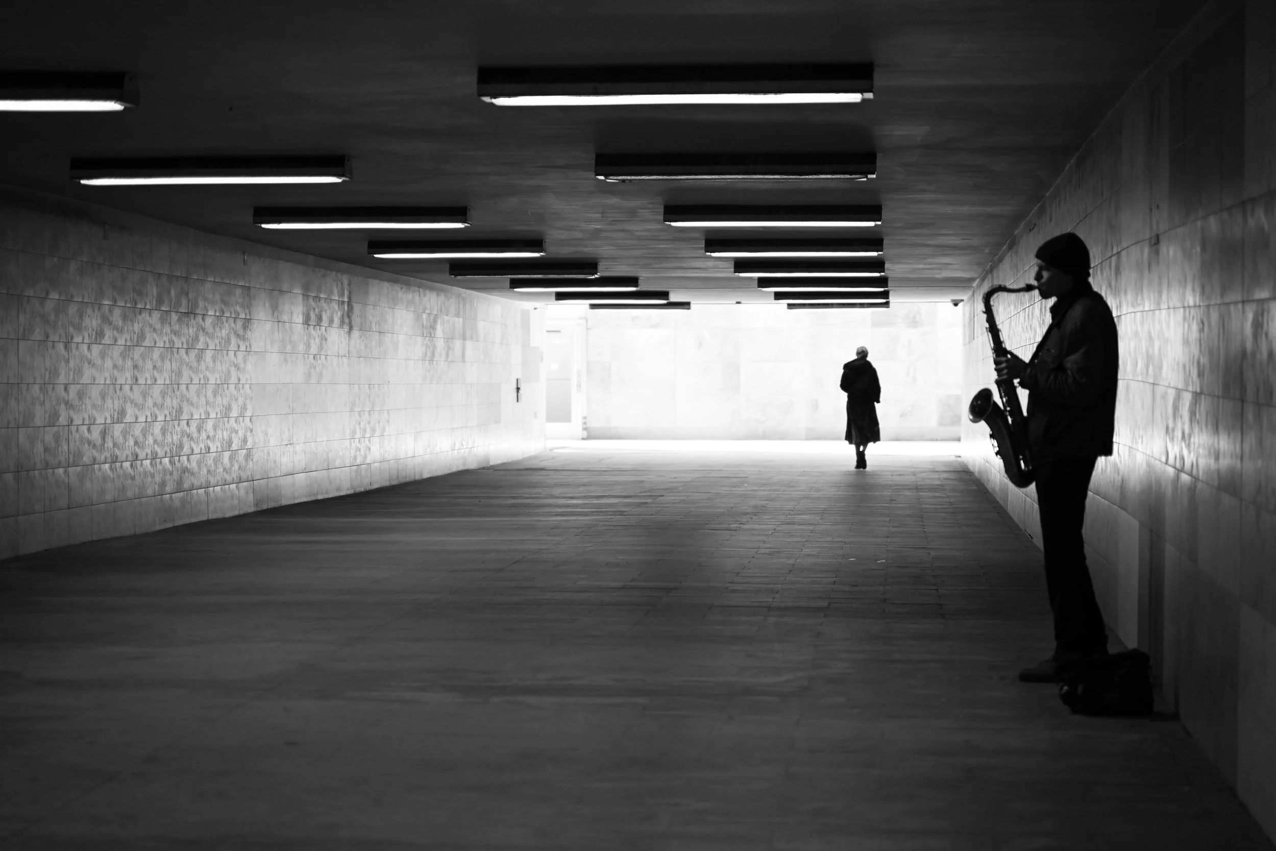 Riga, Latvia. Street musician in an underground passage photographed by Sepa Sama as part of urban photography, public space observation, and walking-based artistic research. Love without Measure.