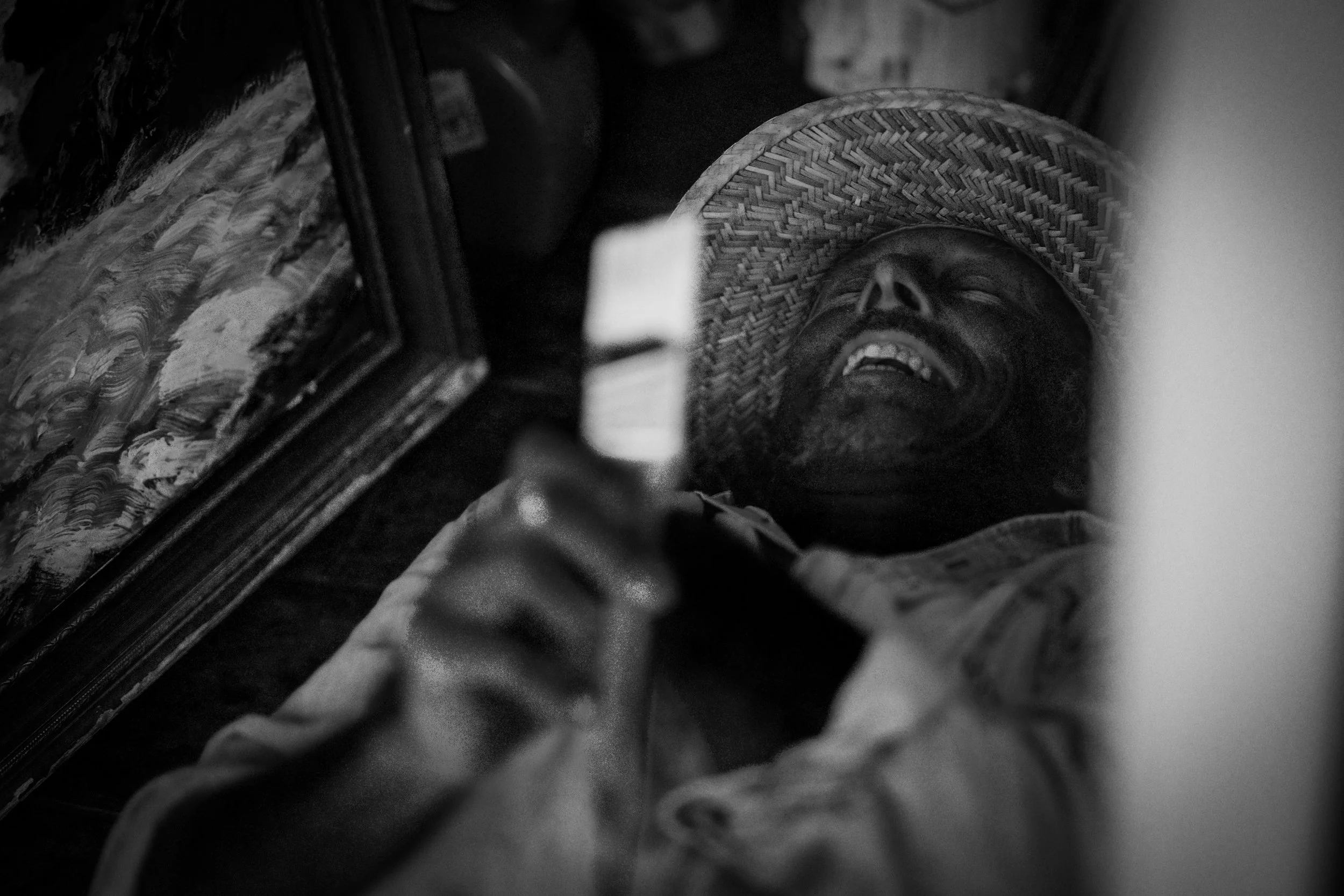 Black-and-white portrait of Will at Boston in Randwick, smiling beneath a woven hat in painterly light and shadow, with a Van Gogh-like atmosphere of texture, warmth, and human presence.