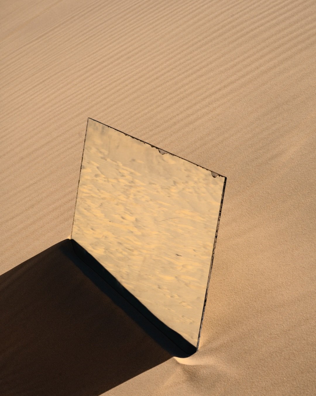 Reflections shifting through the dunes.

More moments from Almost Elsewhere where landscape, body and light begin to blur into one another. Mirrors fragment the scene, distort perspective, and turn the familiar into something harder to place.

This s