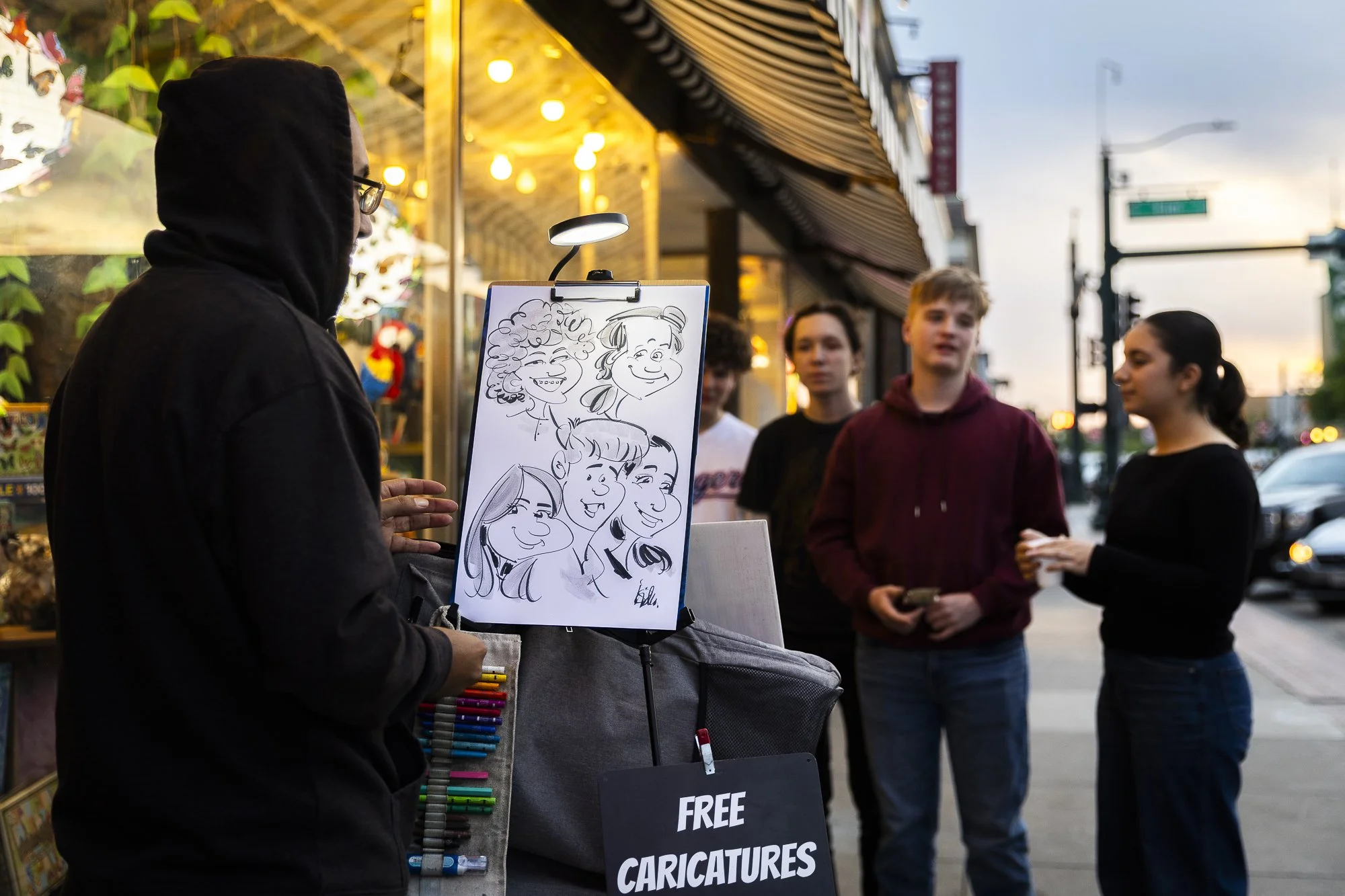 Get Your Picture: Denton artist Isidro Nuñez draws a caricature on the Square in Denton on April 8. Nuñez, who learned the technique as a kid through YouTube, offers his services for free to anyone who has 20 minutes to spare.