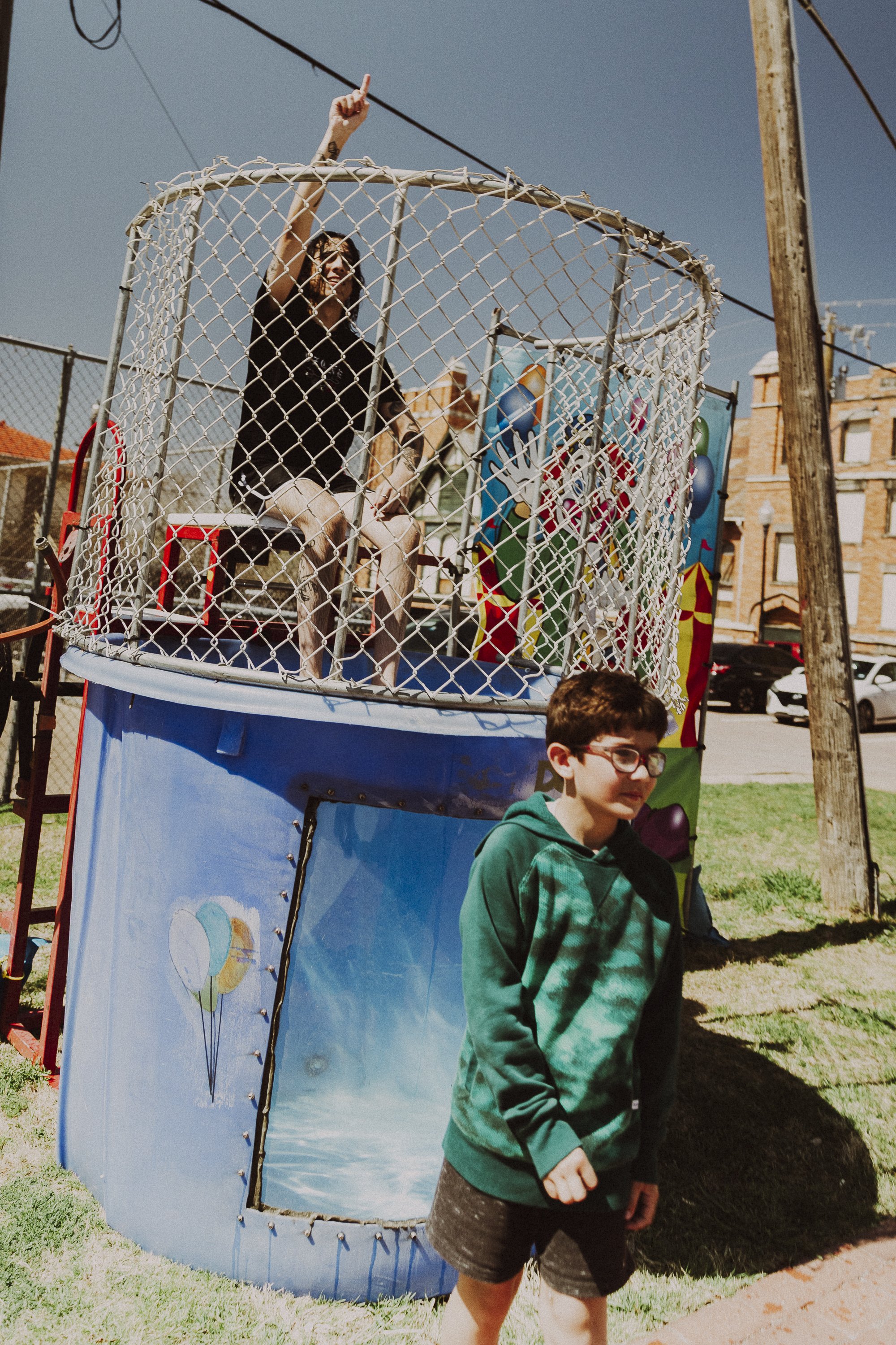 Dunkin' Uri: Trauma Ray’s Uriel Avila applauds Tommy Hurst, 11, for dunking him in the dunk tank before their set at the band’s release show for their EP, “Carnival,” at Fire Station Skate Plaza on March 14. The event was set up like a carnival, with