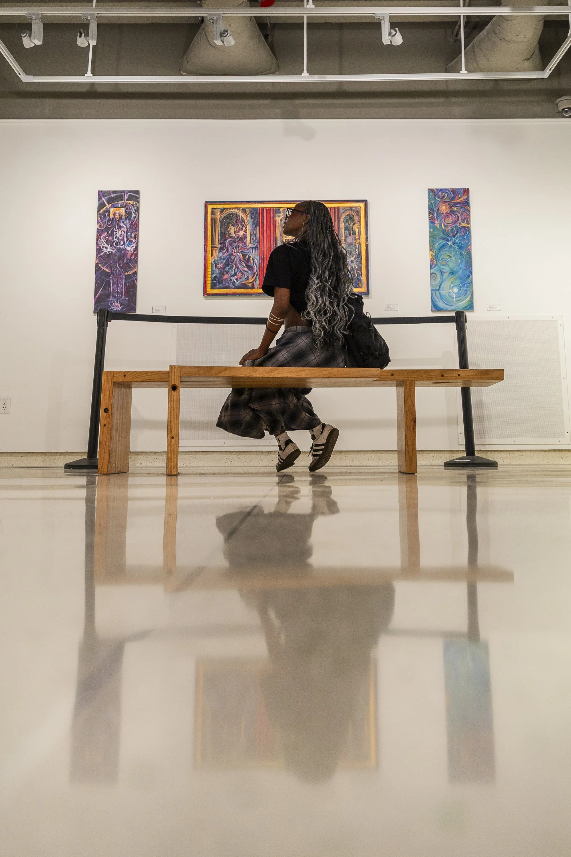 ART APPRECIATION: Junior Lola Popoola admires the art in the Union gallery at the University of North Texas on March 31. Popoola’s parents always pushed her to focus on academics, so she never had time to explore her creative side. “Some people are m