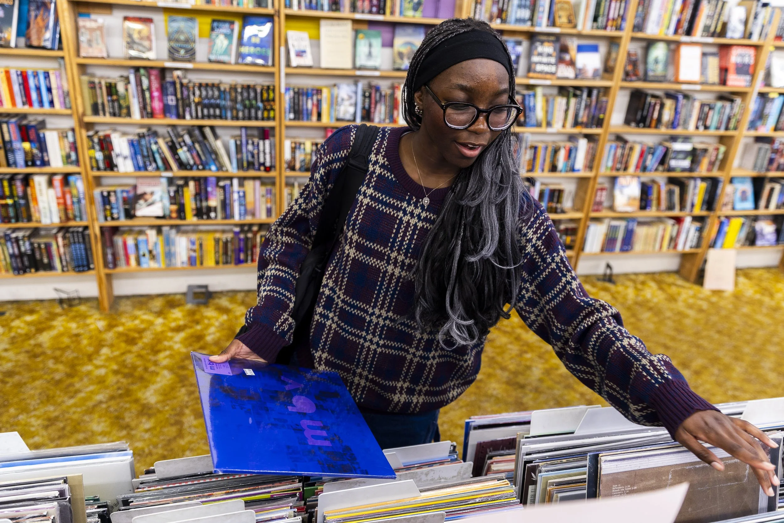 FOR THE RECORD: Junior Lola Popoola shops for records at Recycled Books, Records, & CDs in Denton. Popoola loves music and often attends concerts, but hasn’t been able to go to many because of school and work.